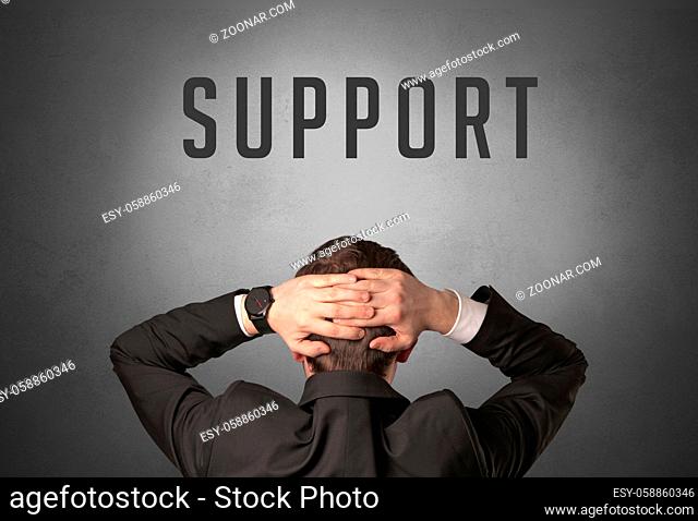 Rear view of a businessman with SUPPORT inscription, powerfull business concept