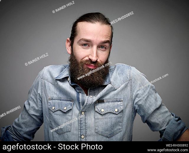 Portrait of man with full beard wearing jeans shirt