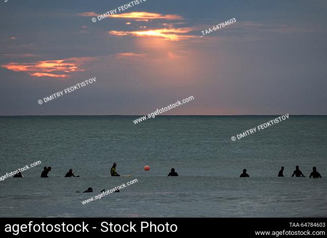 RUSSIA, SOCHI - NOVEMBER 13, 2023: Surfers are seen during a storm on the Black Sea, in the Khosta neighbourhood. Dmitry Feoktistov/TASS