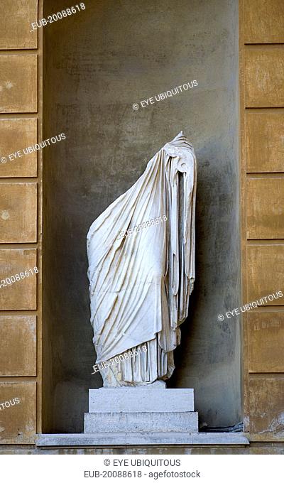 Vatican City Museum Belvedere Palace Marble statue in a niche of the lower half of a man cut in two wearing a toga