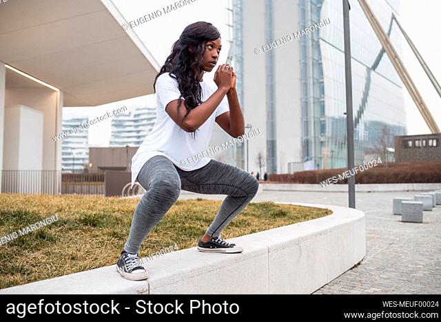 Sportive young woman training in the city
