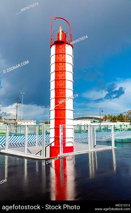 Red and white lighthouse at the Krestovsky island in St. Petersburg, Russia