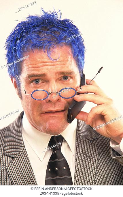 Blue-haired businessman talking on cell phone