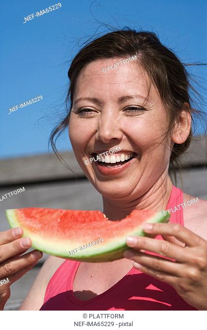 A woman eating a water melon Sweden