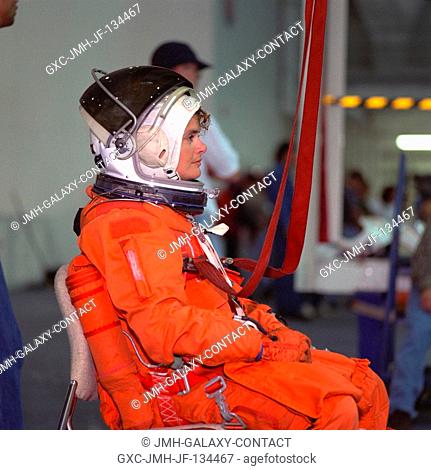 Astronaut Julie Payette stands by to simulate a parachute drop into water during emergency bailout training. The STS-96 mission specialist