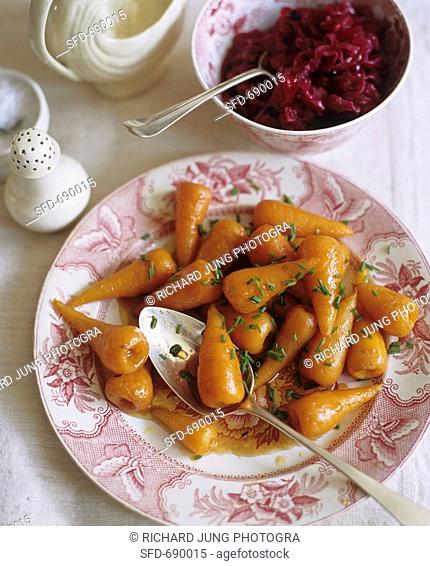 Plate of Roast Baby Carrots with Serving Spoon