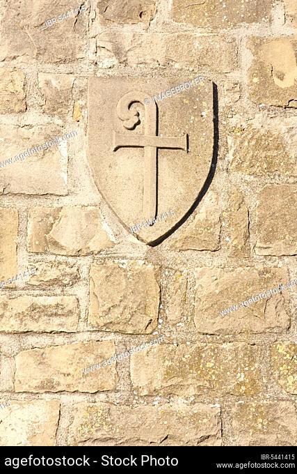 The relief of a cross with a walking stick in a medieval archway, Obanos, Navarra region, Basque Country, Spain, Europe
