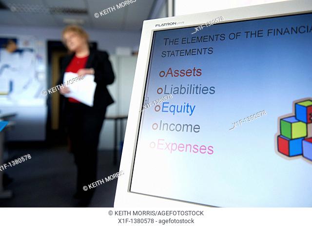 A person making a presentation of financial information in an office, UK