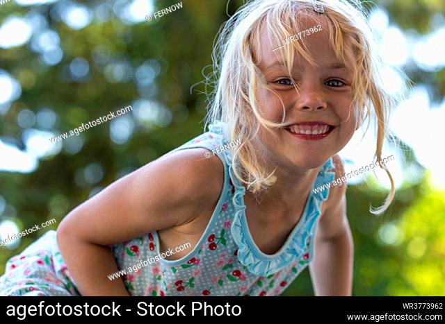 Blond girl smiling at camera, Kiel, Schleswig-Holstein, Germany, Europe