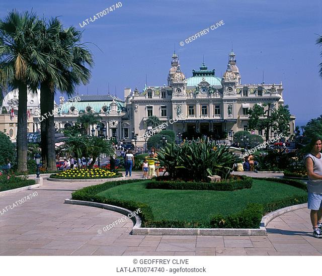 Casino. Large baroque building. Dome. Towers. Formal gardens/ bedding. People