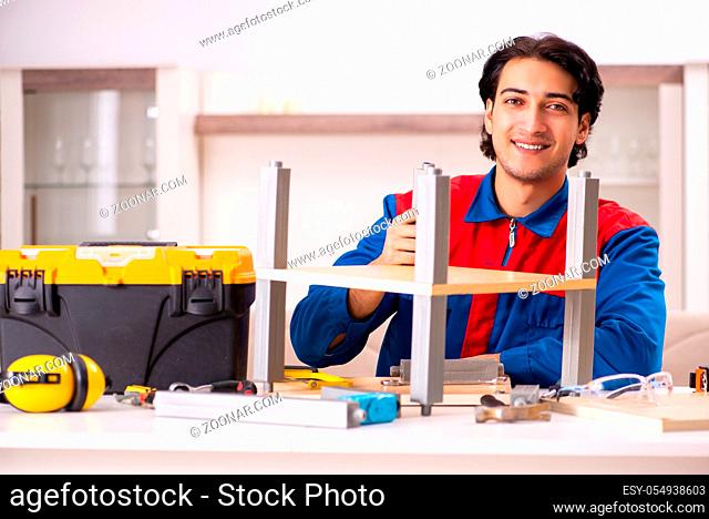 Young contractor repairing furniture at home
