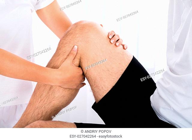 Close-up Of A Therapist Hand Massaging Man's Leg In Spa