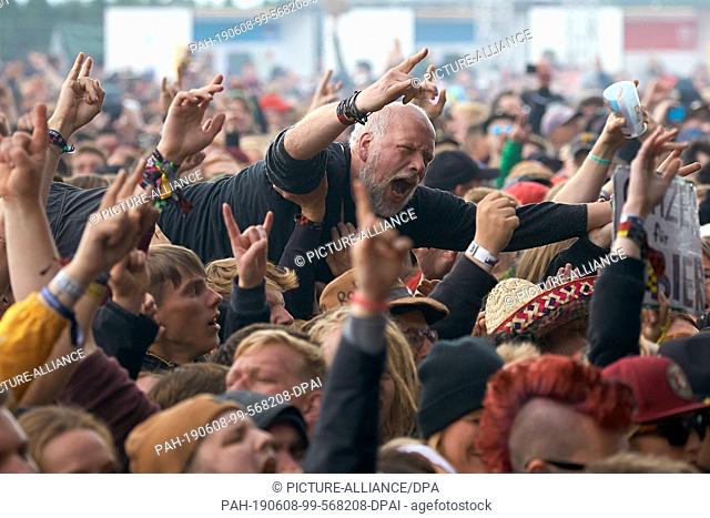 08 June 2019, Rhineland-Palatinate, Nürburg: During the performance of the band ""Feine Sahne Fischfilet"" in front of the main stage of the open-air festival...