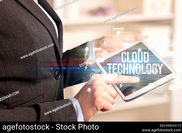 Close-up of a tablet searching CLOUD TECHNOLOGY inscription, modern technology concept