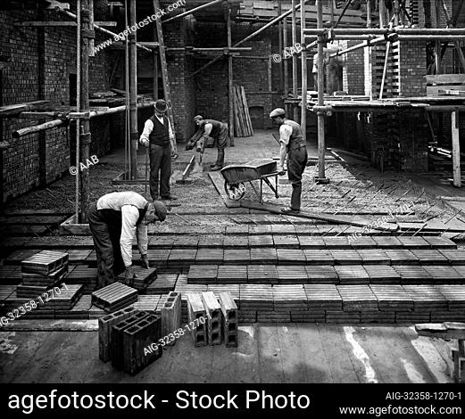 8 LLOYDS AVENUE, City Of London. Construction workers laying a 'hollow pot' reinforced concrete floor at number 8 Lloyds Avenue
