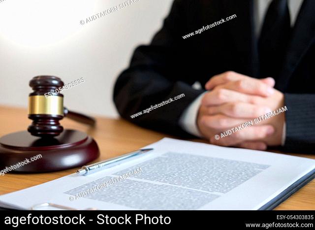 tribunal Attorney lawyer working with documents and wooden gavel on tabel in courtroom. justice advice and law judge legislation concept