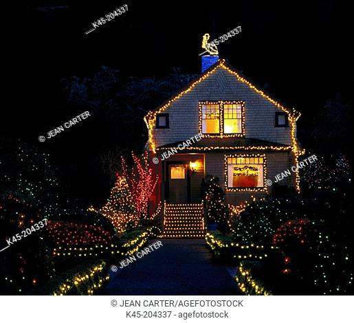 Holiday lights decorate Garden Cottage at Shore Acres State Park, Southern Oregon coast, USA