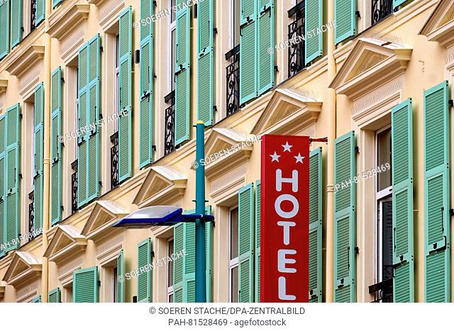 A sign reading 'hotel' with three stars hangs in the old town of Menton, France, 6 June 2016. Menton is close to the Italian border