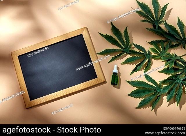 hemp essential oil, chalkboard and cannabis leaves