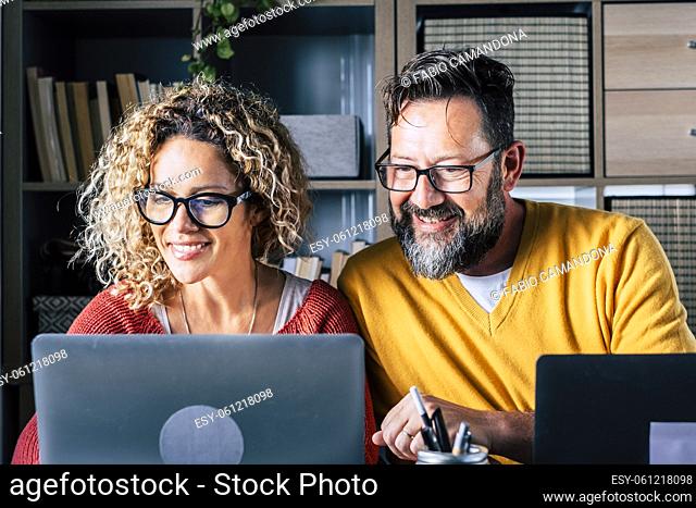 Happy man and woman couple work at home in smart working office activity together with joy - digital modern adult people in online internet job activity -...