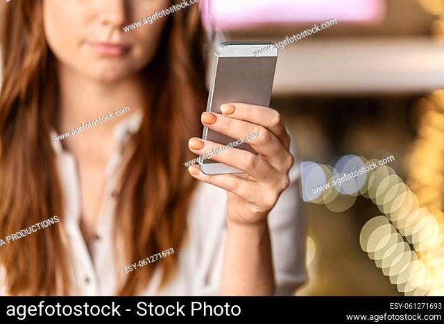 close up of woman with smartphone at restaurant