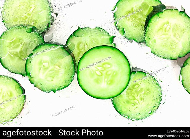 Cucumbers in water, healthy organic cosmetics product on a white background