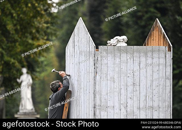 24 October 2023, Brandenburg, Potsdam: Carpenters and joiners from the Schirrhof of the Prussian Palaces and Gardens Foundation Berlin-Brandenburg protect the...