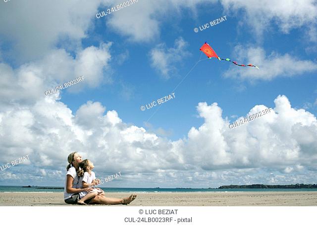 Woman and daughter flying a kite
