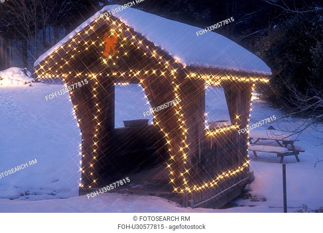 holiday, covered bridge, Christmas, winter, A small covered bridge at The Mountain Road Resort in the ski resort of Stowe is trimmed with tiny white lights and...
