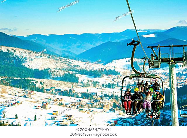 BUKOVEL, UKRAINE - DEC 08, 2015: Skiers on a ski lift in Bukovel. Bukovel is the most popular ski resort in Ukraine