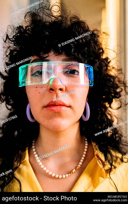 Curly hair woman wearing cyber glasses