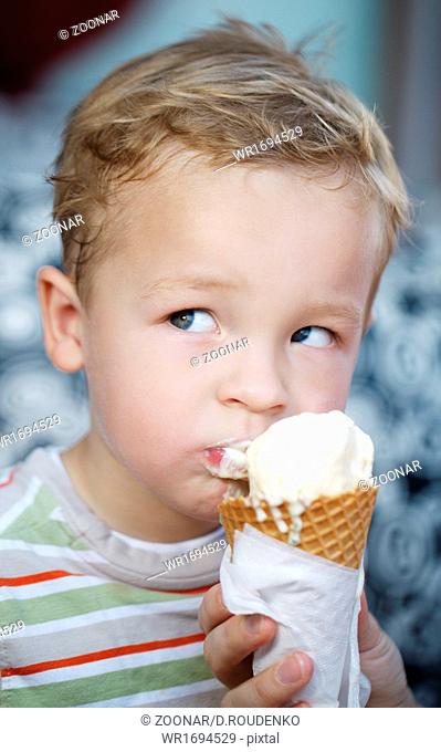 Cute little boy eating an ice cream cone