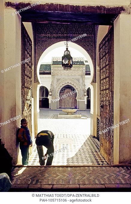Believing Muslims take off their shoes before entering the Kairaouine Mosque in the Moroccan city of Fes, analogue undated photograph from March 1985