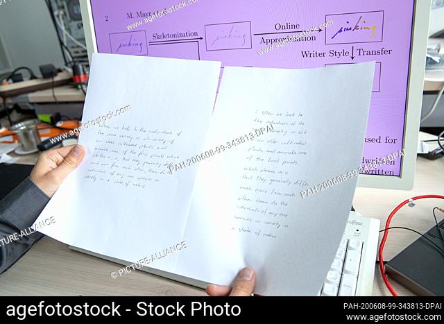 05 June 2020, Bavaria, Erlangen: A research assistant from the Chair of Pattern Recognition at the University of Erlangen-Nuremberg holds printouts of a pattern...