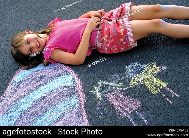 Young Girl Takes a Break From Sidewalk Art