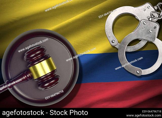 Colombia flag with judge mallet and handcuffs in dark room. Concept of criminal and punishment, background for guilty topics