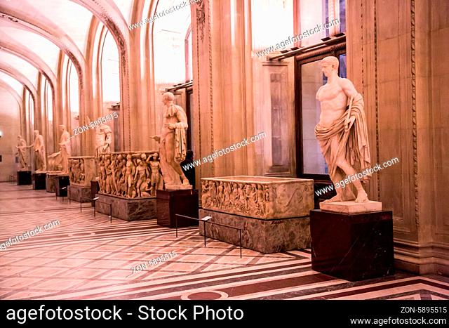 PARIS - JULY 22: Ancient statues at the Louvre, on July 22, 2012 in Louvre Museum, Paris, France. With 8, 5m annual visitors