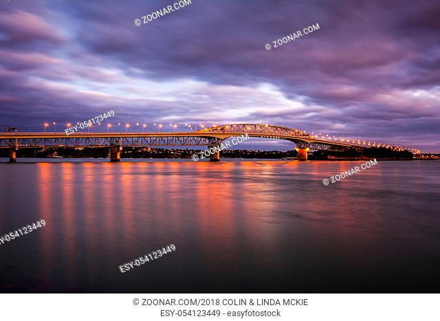 Auckland Harbour Bridge - Auckland Harbor Bridge with its lights on at twilight