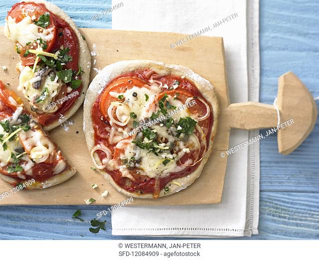 Tomato pizzas with anchovies and gremolata