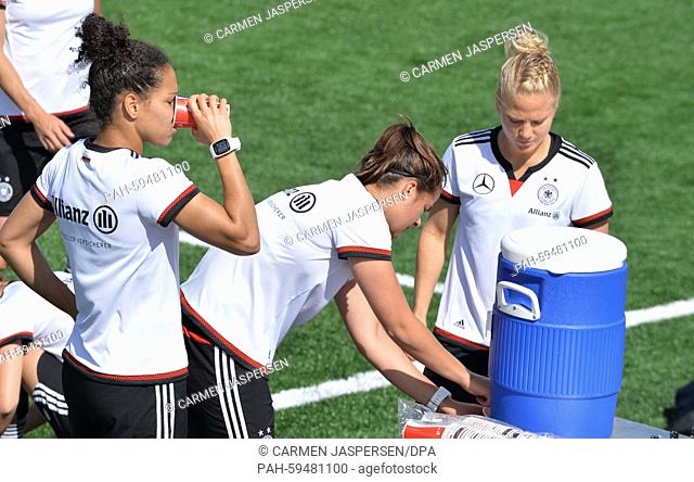 Germany's (L-R) Celia Sasic, Lena Lotzen and Leonie Maier drink during a training session at the FIFA Women's World Cup 2015 at the Avenue Bois-de-Boulogne