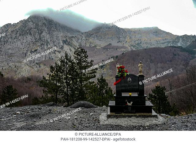 27 October 2018, Albania, Malësia e Madhe: A memorial stone for a victim on a mountain road in the region of Malësia e Madhe in the Albanian Alps