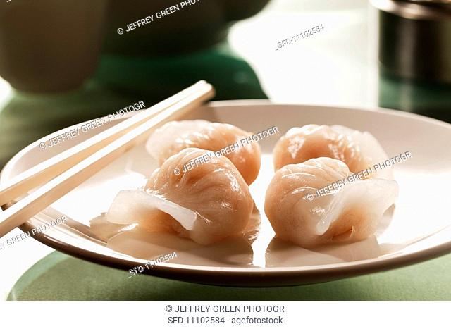 Steamed Chinese Dumplings on a Plate with Chopsticks