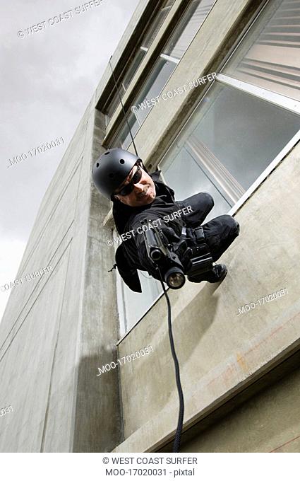 SWAT Team Officer Rappelling from Building