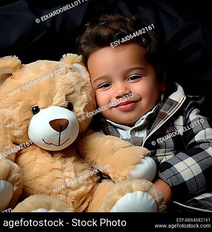 Portrait of a young boy holding a teddy bear with soft lighting