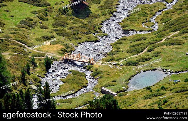 A wooden bridge over a mountain torrent in Upper Engadine near Muottas Muragl | usage worldwide. - St Moritz/Graubünden/Switzerland