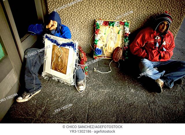 Pilgrims sleep in the street by an image of the Our Lady of Guadalupe virgin in Mexico City, December 6, 2008  Millions of Mexican pilgrims converged on the Our...