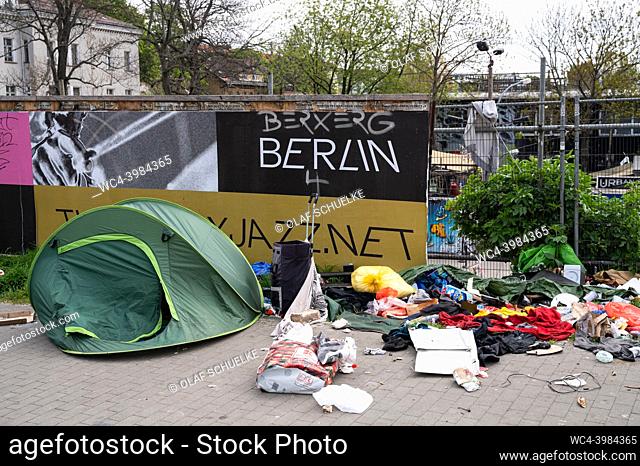 Berlin, Germany, Europe - The tent of a homeless person is seen next to a pile of waste along the Warschauer Strasse in front of the site of the RAW-Gelaende in...