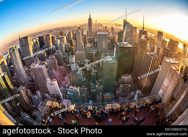 New York City, United States of America - March 24: Manhattan downtown skyline with Empire State Building and skyscrapers at sunset seen from Top of the Rock...