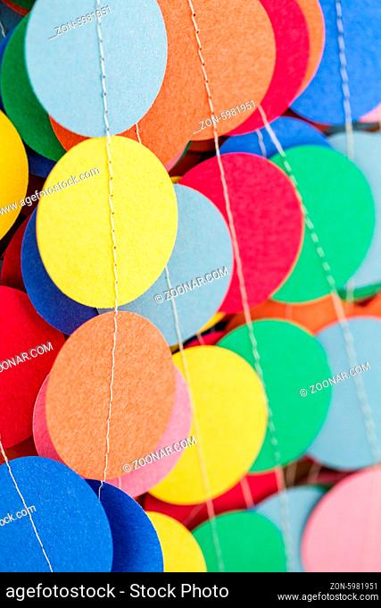 Making a colorful paper garland with reound puncher