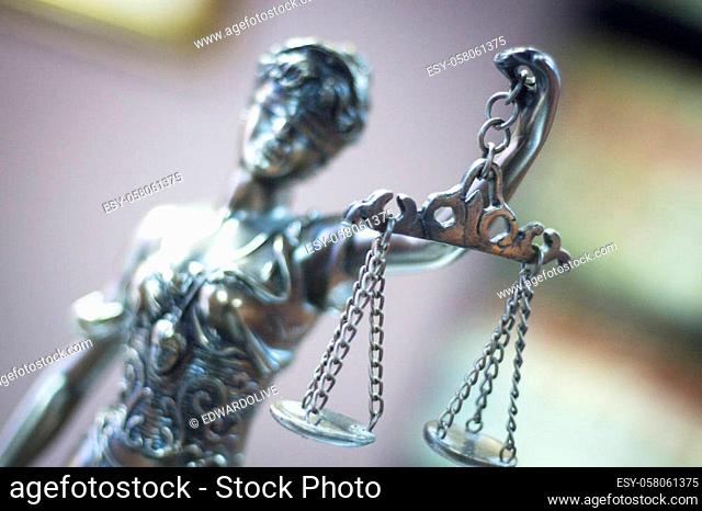 Legal blind justice metal statue with scales in chain in law firm offices photo